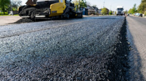 Residential Asphalt. Worker,Operating,Asphalt,Paver,Machine,During,Road,Construction,And,Repairing