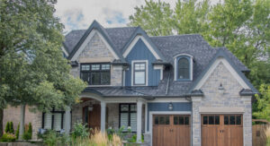 Residential Interlocking Services. A,Large,Modern,Multi,Level,Residential,Executive,Home,With,Brown garage doors with interlocking driveway.