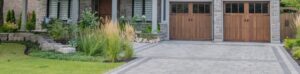 Residential Interlocking Services. A,Large,Modern,Multi,Level,Residential,Executive,Home,With,Brown garage doors with interlocking driveway.