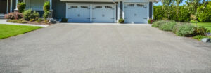 Residential Asphalt Services. Wide,Asphalt,Driveway,Of,Residential,House,With,Three,Doors,Garage